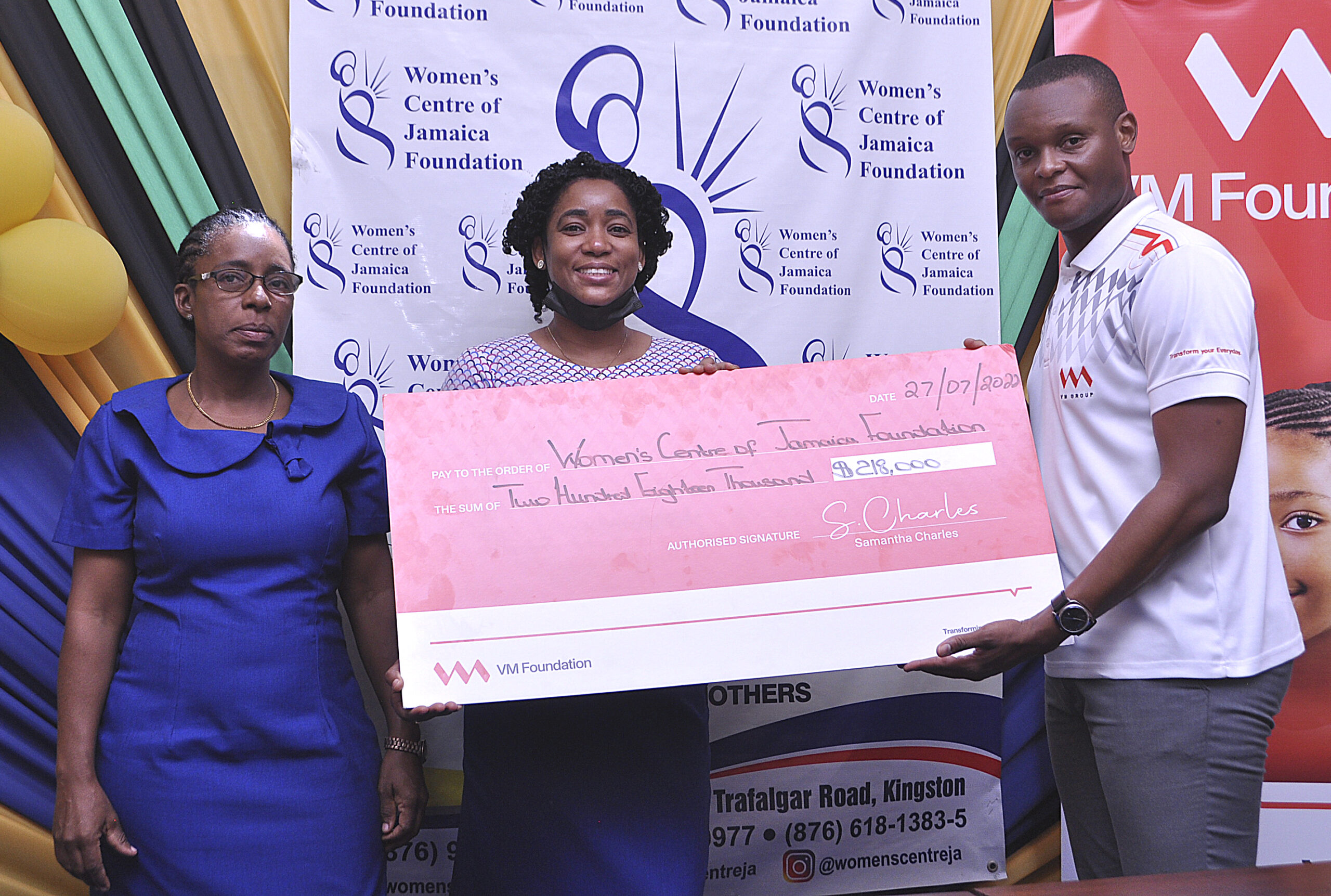(From left) Natalie Fuller, Projects Coordinator, and Marlene Murray-Brown, Counsellor at the Kingston Office of the Women’s Centre of Jamaica Foundation, receive a cheque courtesy of the VM Foundation. Making the presentation is Andre Alleyne, Assistant Supervisor for Customer Service at VM Building Society - New Kingston Branch.